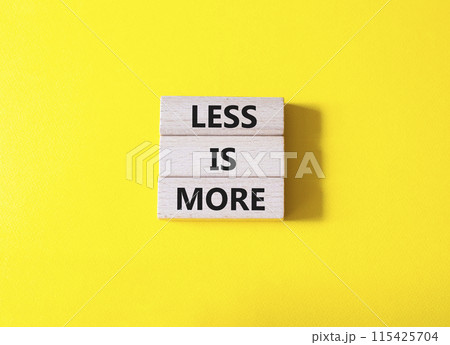 Less is More symbol. Concept words Less is More on wooden blocks. Beautiful yellow background. Business and Less is More concept. Copy space. 115425704