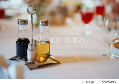 Set of containers for spices, oil and vinegar on a metal stand Set of containers for spices, oil and vinegar on a metal stand 115425893