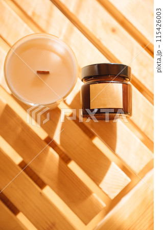 Scented candles on a wooden table.  115426003