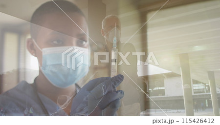 Image of female doctor with covid 19 vaccine over senior man wearing face mask Image of female doctor with covid 19 vaccine over senior man wearing face mask 115426412