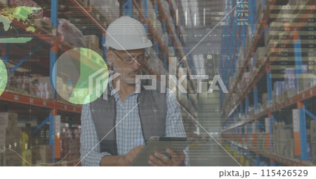 Male worker in hard hat checks packages, analyzes digital graphs. 115426529