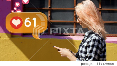Side view of a Caucasian woman walking on the sidewalk while typing on her phone Side view of a Caucasian woman walking on the sidewalk while typing on her phone 115426606