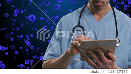 Image of midsection of caucasian male doctor over blue cells on navy background 115427521