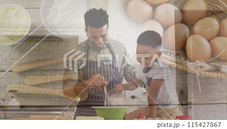 Image of happy african american father and son baking over eggs and basket 115427867