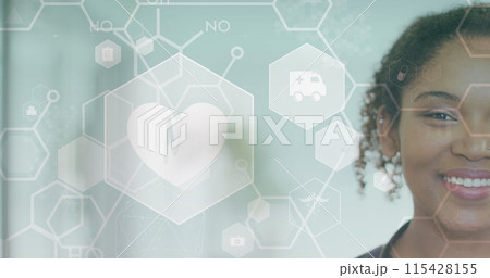 Image of heart beat, medical icons and cells over smiling african american female doctor 115428155