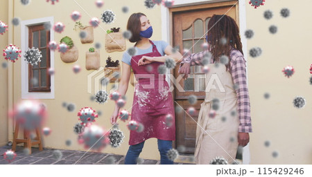 Image of covid 19 cells over two women in pottery studio wearing face masks greeting with elbows Image of covid 19 cells over two women in pottery studio wearing face masks greeting with elbows 115429246