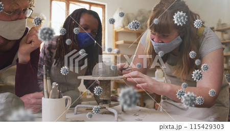 Composite image of covid-19 cells against group of diverse female potters working on pottery wheel Composite image of covid-19 cells against group of diverse female potters working on pottery wheel 115429303