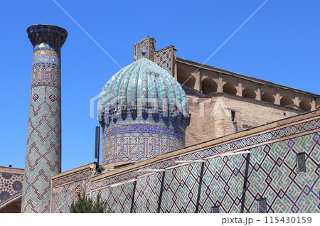 Sher-dor Madrassah, Registan complex, Samarkand, Uzbekistan. Wall, dome and decorative minaret with tile decor, Sher Dor (Lion) Medressa, part of Registan Ensemble 115430159