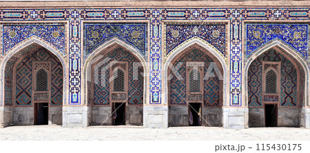 Famous landmark - Sher-Dor Madrasah on Registan square, Samarkand, Uzbekistan. Arches with tile ornament in the courtyard of She -Dor Madrasa 115430175