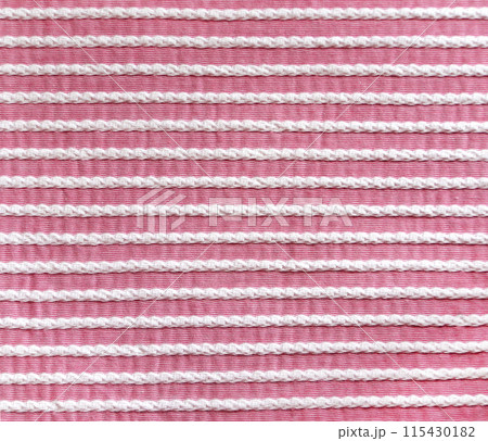 Light pink and white style striped fabric texture. Background with  striped closeup weave fabric. Pinstripe material of pink and white color 115430182