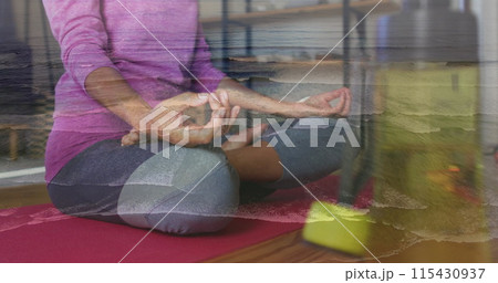 Image of wave over biracial women practicing yoga 115430937