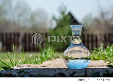 Reflection of a concrete road in a vase with clear water Reflection of a concrete road in a vase with clear water 115431566
