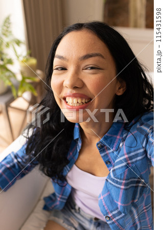 Young biracial woman smiles brightly 115431598