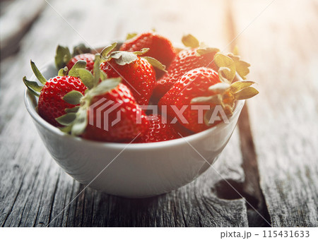 Strawberry, bowl and table with healthy food and fruit for wellness, nutrition and to lose weight. Home, breakfast and sustainable meal or health snack with vitamin A and diet dessert for eating 115431633
