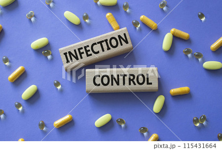 Infection Control symbol. Concept word. Infection Control on wooden blocks. Beautiful purple background with pills. Medicine and Infection Control concept. Copy space 115431664