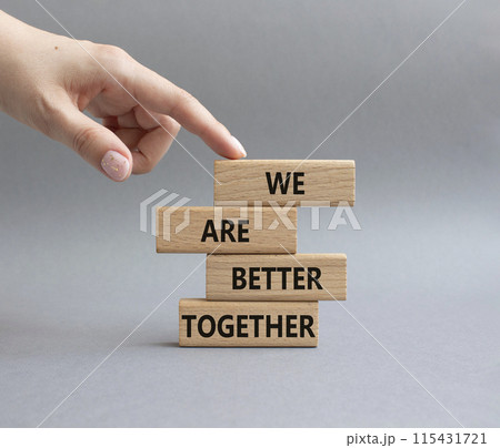 We are better together symbol. Wooden blocks with words We are better together. Beautiful grey background. Businessman hand. We are better together concept. Copy space. 115431721