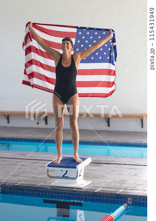Caucasian female athlete swimmer celebrates victory at a swimming pool 115431949