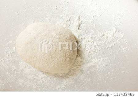 A ball of dough sits amidst a dusting of flour on a surface with copy space A ball of dough sits amidst a dusting of flour on a surface with copy space 115432468