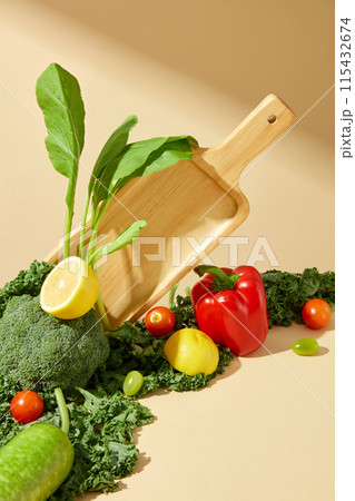Photo taken from the front of a corner in the vegetable garden, on yellow background. Vacant space on the right side for displaying dietary or vegan products, copy space for text 115432674
