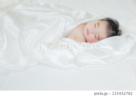 白い布に包まれて寝ている赤ちゃん　 115432782