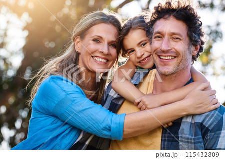 Family, portrait and piggyback hug for girl with parents in a park with love, games and fun bonding in nature. Support, freedom and people in a forest for back ride, travel and trust on vacation trip 115432809