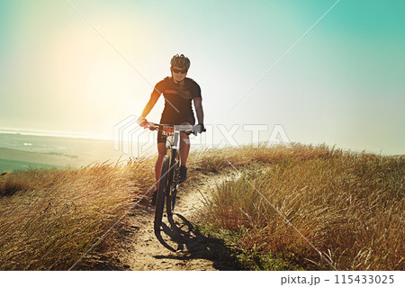 Morning, cycling and mountain bike with fitness, training and adventure on a dirt path. Bicycle, person and cardio of athlete with sport and exercise for race workout outdoor with cyclist journey 115433025