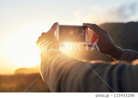 Sunset, phone and hand of person with picture for travel blog, update and memory of holiday. Sky, nature and screen of technology with photography in evening for social media, post and adventure 115433206