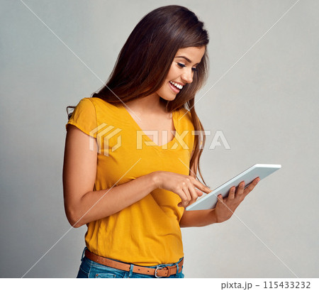 Woman, smile and browse tablet in studio background for social media, networking and communication. Female person, happy and satisfied with good news, streaming platform and website fro entertainment 115433232