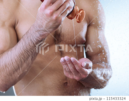 Hands, man and soap with closeup in shower for grooming, health and hygiene for wellness in bathroom. Skincare, dermatology and water for cleaning, cosmetics and muscular male person for body care 115433324