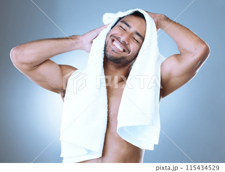 Man, excited and clean with towel for hygiene, skincare and grooming in blue background. Male person, shower fresh and healthy for wellness, confidence and cosmetic with happiness in studio backdrop 115434529