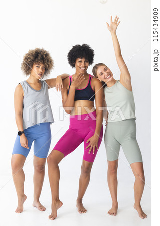 Diverse group of women posing in fitness attire Diverse group of women posing in fitness attire 115434909