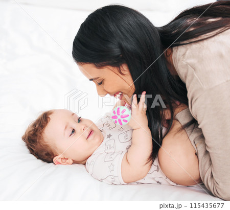 Mother, hug and baby on a bed with love, care and morning bonding games in their home together. Happy family, child development and woman playing with son in a bedroom with support, safety and trust 115435677