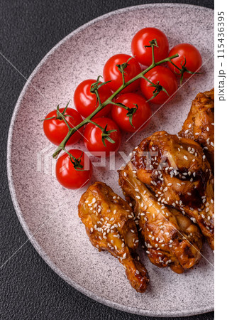 Delicious crispy grilled wings with teriyaki sauce with salt, spices Delicious crispy grilled wings with teriyaki sauce with salt, spices 115436395