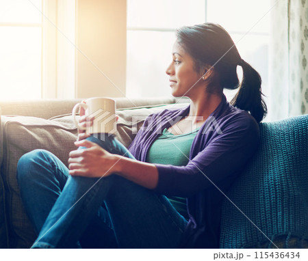 Thinking, drinking coffee and Indian woman in house living room for morning breakfast, vision or remember. Tea, dream and person on sofa for peace, calm and planning future decision in home to rest 115436434