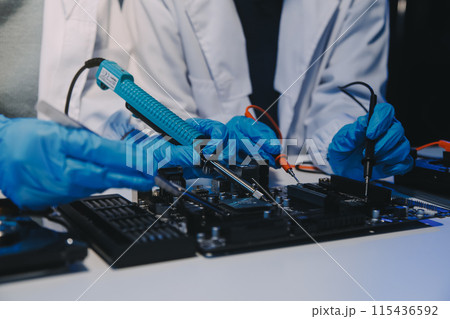 Close up of Technician measuring voltage electronic circuit board television, Service after sale fix electric equipment within insurance. Close up of Technician measuring voltage electronic circuit board television, Service after sale fix electric equipment within insurance. 115436592