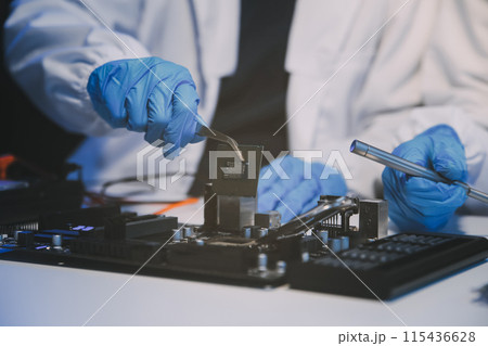 Close up of Technician measuring voltage electronic circuit board television, Service after sale fix electric equipment within insurance. 115436628