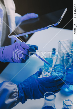 chemist,scientist hand dropping chemical liquid into test tube, science research and development concept 115436643