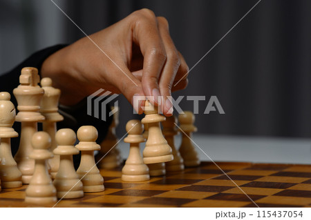 Businesswoman moving a chess piece on a chess board. Business competition strategy and management concept 115437054