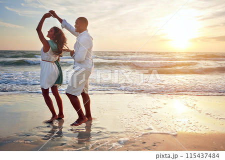 Couple, celebrate and dance on beach with outdoor romance, holiday and vacation by ocean or sunset space. Happy people spinning and holding hands with love and travel on anniversary or valentines day Couple, celebrate and dance on beach with outdoor romance, holiday and vacation by ocean or sunset space. Happy people spinning and holding hands with love and travel on anniversary or valentines day 115437484