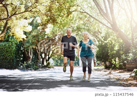 Running, outdoor and old couple with sunshine, exercise and bonding together with retirement. Park, senior man and mature woman with training, challenge and hobby with fitness, summer and wellness 115437546