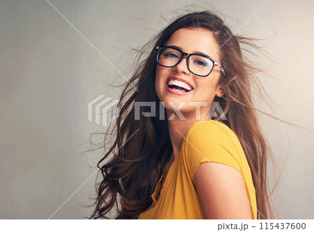 Woman, portrait and happy with glasses in studio background as prescription, eyewear and eyesight. Female person, smile and satisfied or confident with frame for spectacles, lens and service 115437600