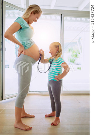 Stethoscope, bonding and child with pregnant mother listening to heartbeat of baby for doctor role play. Happy, happy and girl kid with medical equipment on belly of mom for prenatal checkup at home. 115437724