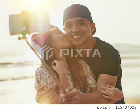 Selfie, couple and kiss on beach for love, support and together in nature with sunshine. Technology, man and woman outdoor for travel, adventure and holiday to Thailand for happiness in summer 115437925