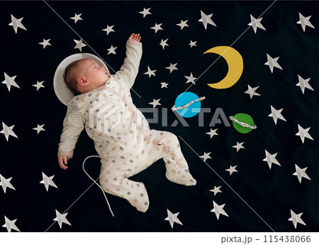 Baby, sleeping and stars on blanket for nap as top view with space dreaming, comfortable or tired. Child, resting and rest on comforter with planets as future astronaut for development, home or peace 115438066