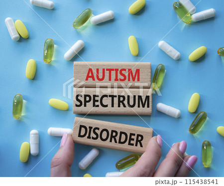 Autism Spectrum Disorder symbol. Concept word Autism Spectrum Disorder on wooden blocks. Doctor health. Beautiful blue background with pills. Medicine and Autism Spectrum Disorder concept. Copy space Autism Spectrum Disorder symbol. Concept word Autism Spectrum Disorder on wooden blocks. Doctor health. Beautiful blue background with pills. Medicine and Autism Spectrum Disorder concept. Copy space 115438541