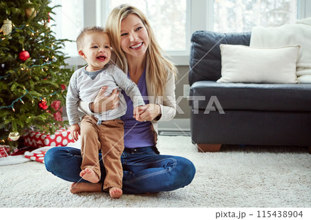 Woman, baby and hug while on floor in living room, bonding for love and christmas holiday. Parent, motherhood and toddler with mother together, happy and play by sitting for relationship at home Woman, baby and hug while on floor in living room, bonding for love and christmas holiday. Parent, motherhood and toddler with mother together, happy and play by sitting for relationship at home 115438904