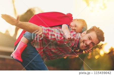 Child, man and piggyback for airplane in portrait for fun, fantasy or development in garden. Young boy, father or playing outside in evening for flying, entertainment or games in backyard for bonding Child, man and piggyback for airplane in portrait for fun, fantasy or development in garden. Young boy, father or playing outside in evening for flying, entertainment or games in backyard for bonding 115439042