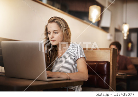 Woman, serious and research at cafe with laptop as university student for elearning or online education. Female learner, studying and revision with distance leaning for college exams and project 115439077