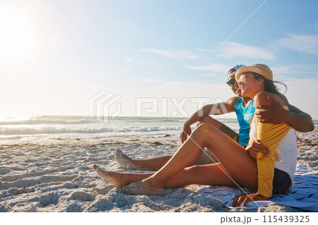 Couple, picnic and hug at beach with sunglasses, sunshine and relax for vacation by ocean in summer. Man, woman and happy on sand in Miami with blue sky, sun and partner on date for holiday or love 115439325