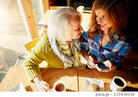 Senior woman, daughter browsing and smile with smartphone in cafe for social media with memories. Funny, post and restaurant for relaxing with coffee, muffin and sunshine in retirement with excited. 115439538